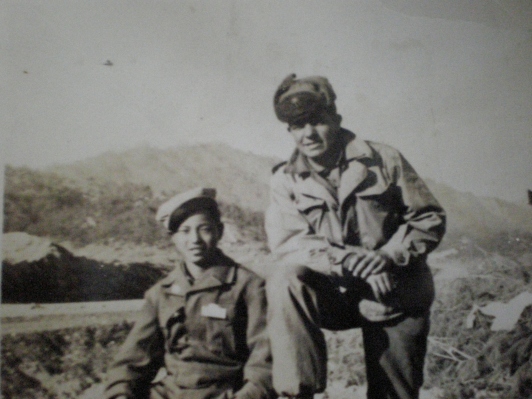 With his friend during the Korean War.